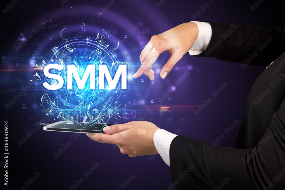 Close-up of a touchscreen with SMM abbreviation, modern technology concept Close-up of a touchscreen with SMM abbreviation, modern technology concept
