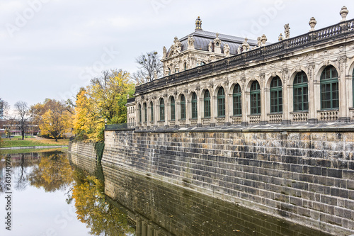 Colorful autumn view of Zwinger from channel. Zwinger Palace was royal palace XVII century in Dresden, Germany. 