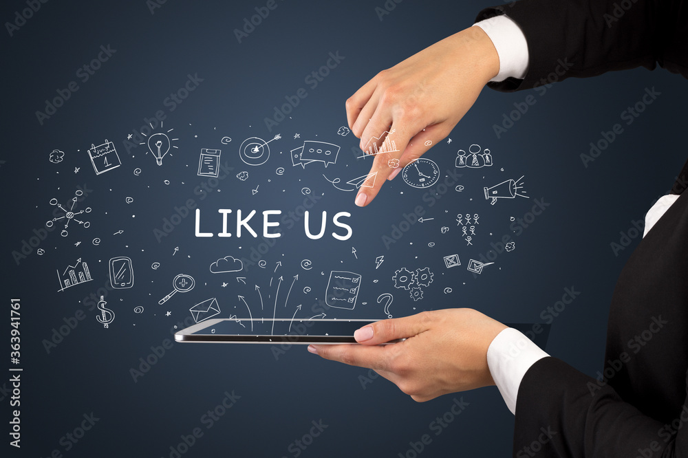 Close-up of a touchscreen with LIKE US inscription, social media concept Close-up of a touchscreen with LIKE US inscription, social media concept