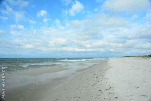 Beautiful seascape with a dark blue sea  long coast line  sandy beach and blue sky on a sunny day.
