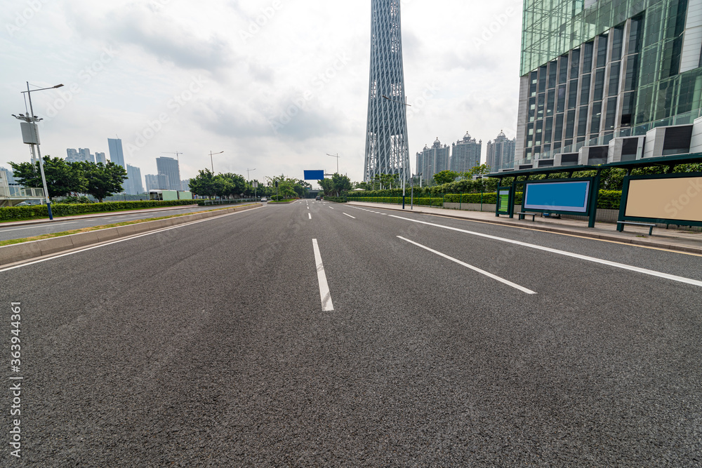 Asphalt road and building near guangzhou TV tower.