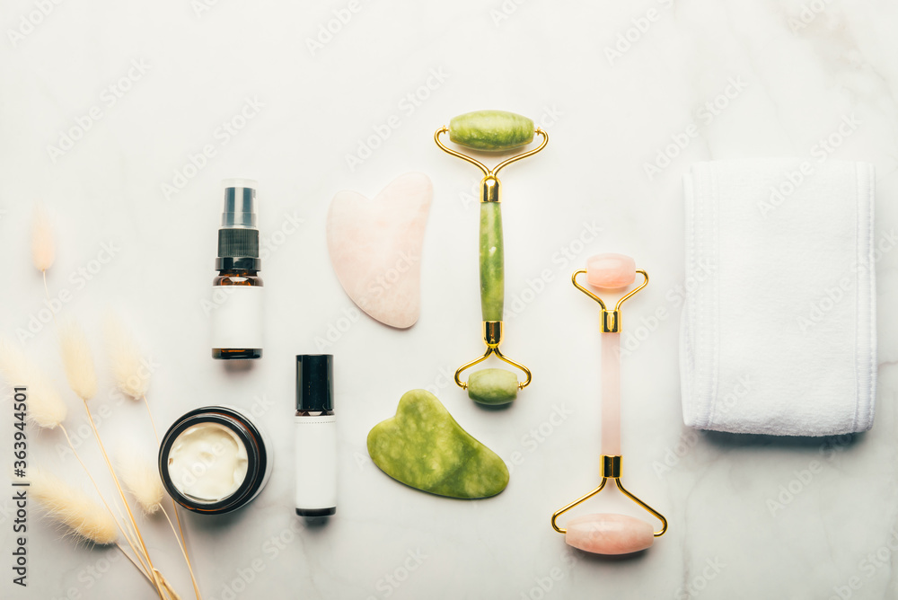 Jade face rollers and Gua sha stones for beauty facial massage therapy, Items for home treatment with Skin Care Anti-Aging Tools, Headband, Face Serum, Coconut Oil and Moisturiser Cream Jade face rollers and Gua sha stones for beauty facial massage therapy, Items for home treatment with Skin Care Anti-Aging Tools, Headband, Face Serum, Coconut Oil and Moisturiser Cream