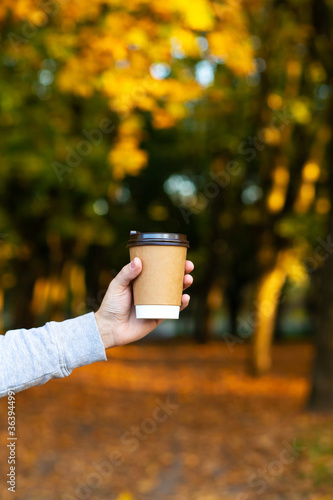 Walk with a cup of hot cocoa in the autumn park.