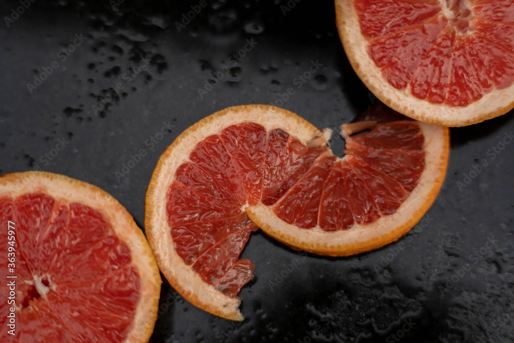 Grapefruit close up on black stone background Grapefruit close up on black stone background
