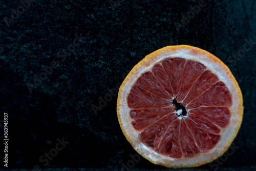 Grapefruit close up on black stone background