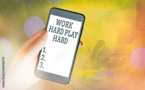 Handwriting text Work Hard Play Hard. Conceptual photo diligent in any activity Party at weekends Hardworking Modern gadgets with white display screen under colorful bokeh background photo