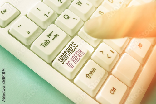 Handwriting text Shorthness Of Breath. Conceptual photo intense tightening of the airways causing breathing difficulty Pc keyboard key with pointing finger above background copy space photo