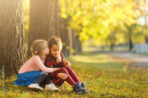 two little girls in autumn park © Angelov