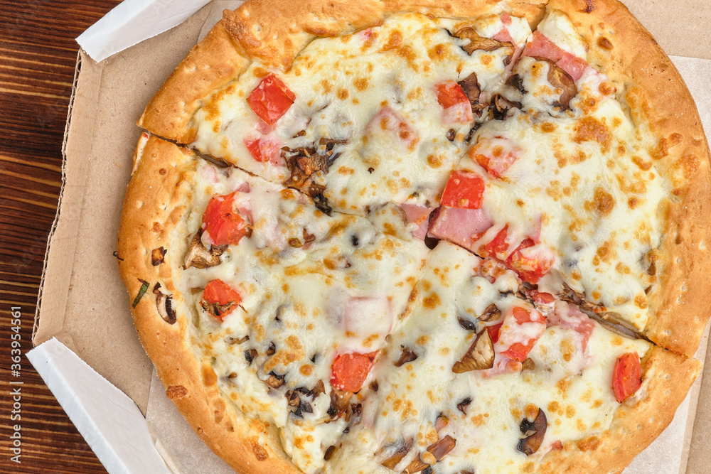 Carbonara pizza in carton packs on a wooden background Carbonara pizza in carton packs on a wooden background