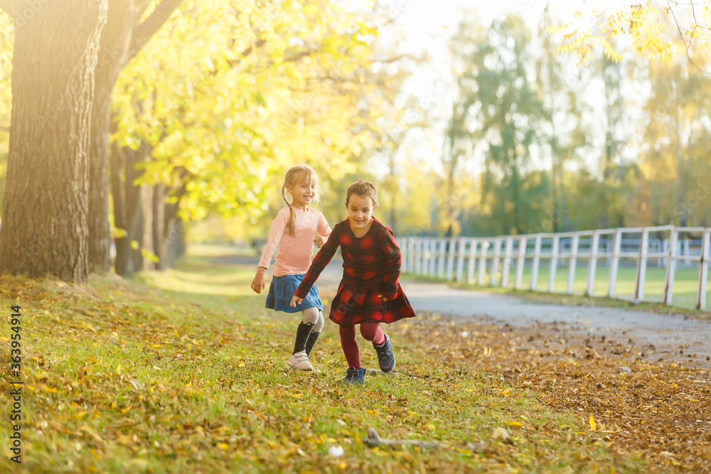 Fototapeta premium two little girls in autumn park