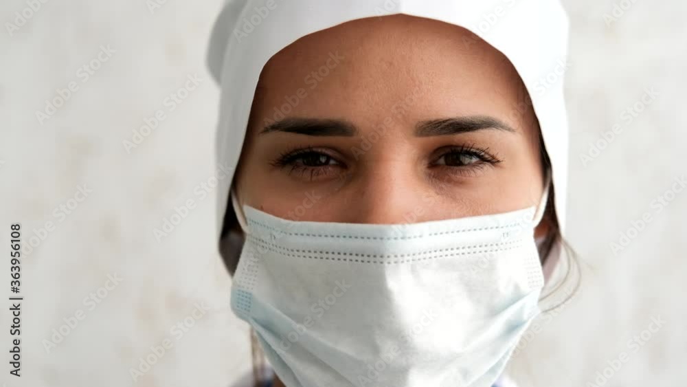 A nurse with a mask during a coronavirus pandemic. Close in Slow Motion. A nurse with a mask during a coronavirus pandemic. Close in Slow Motion.