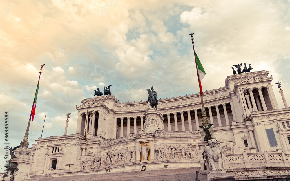 Rome Italy, King Vittorio Emanuele monument impressive facade under cloudy sky, filtered image
