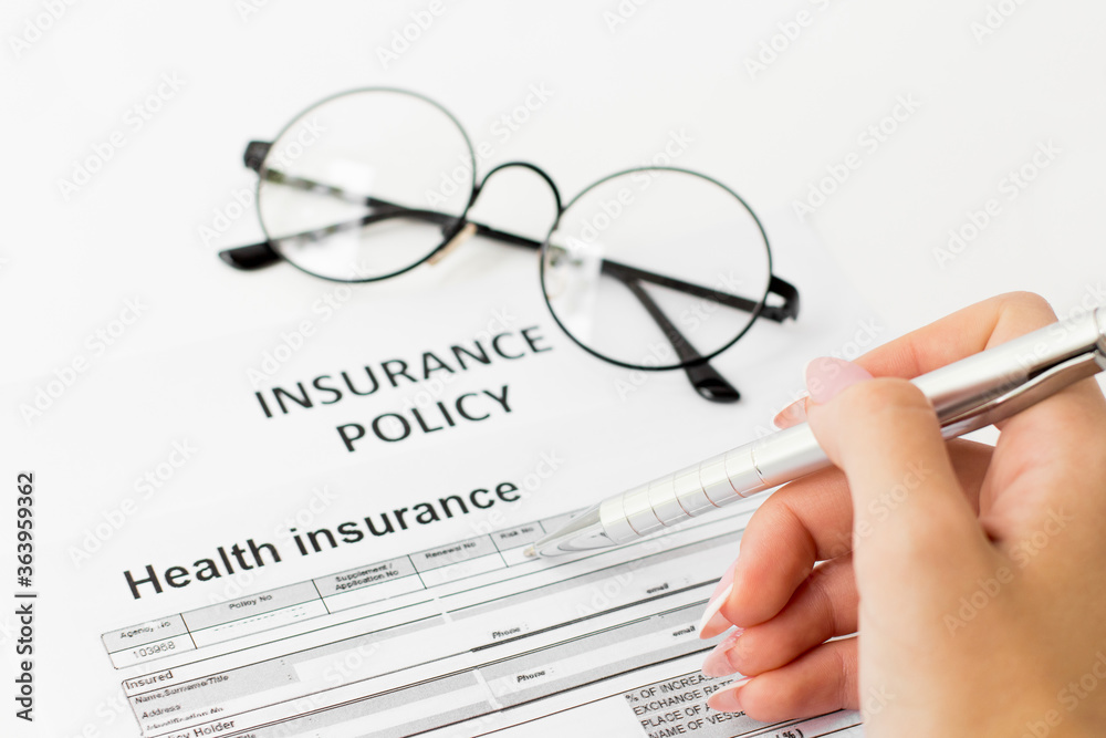 insurance policy form on desk in office showing risk concept insurance policy form on desk in office showing risk concept