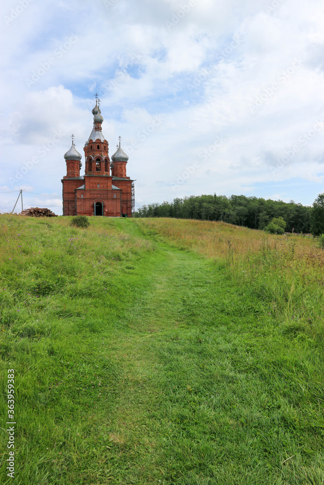 Beautiful Transfiguration Church made from red brick near the Volga source. Russia