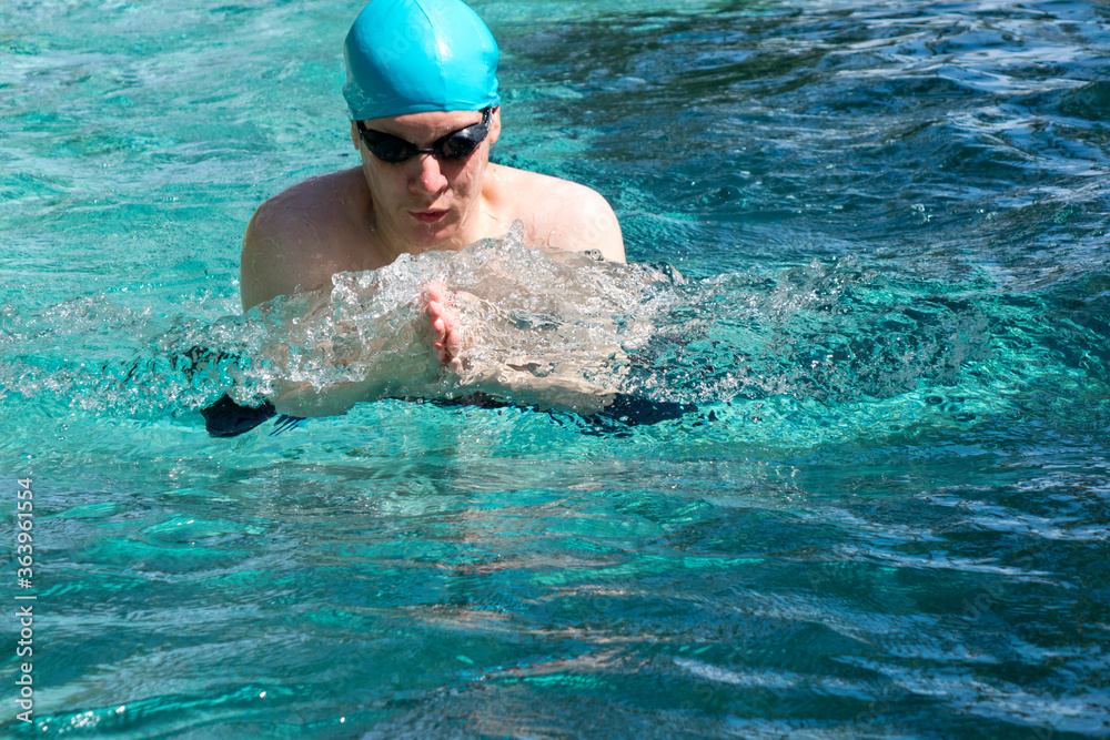 The young man swims sports style