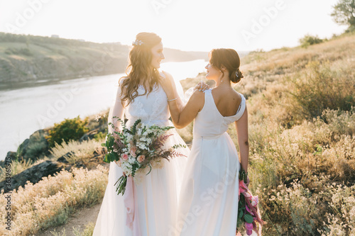 Lesbian wedding couple in white dresses