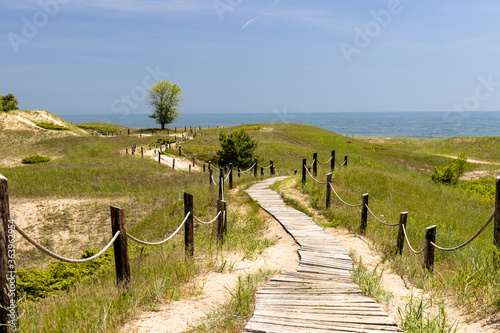 Fototapeta Naklejka Na Ścianę i Meble -  A boardwalk over coastal dunes leads to lake michigan at a state park in Wisconsin