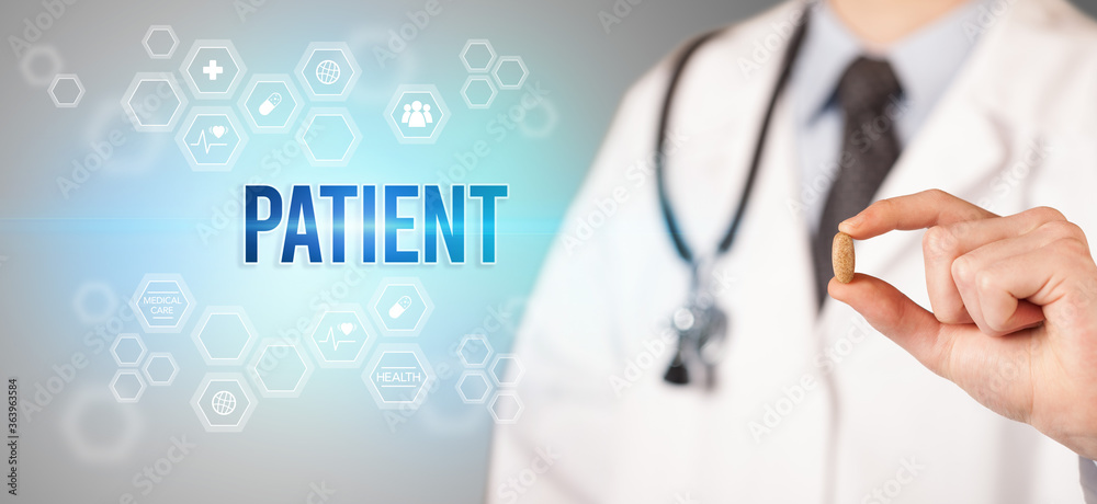 Close-up of a doctor giving you a pill with PATIENT inscription, medical concept Close-up of a doctor giving you a pill with PATIENT inscription, medical concept