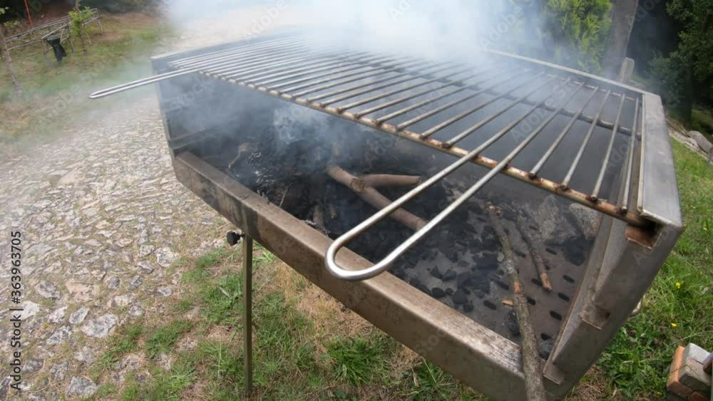 SLOW MOTION SHOT - Preparation of barbecue with charcoal. Background of smoldering charcoal. BBQ with ember in close-up. SLOW MOTION SHOT - Preparation of barbecue with charcoal. Background of smoldering charcoal. BBQ with ember in close-up.