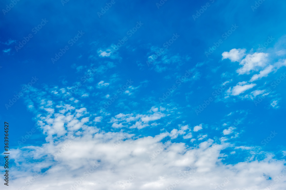 Blue skyline with fragmented clouds formation on the bottom