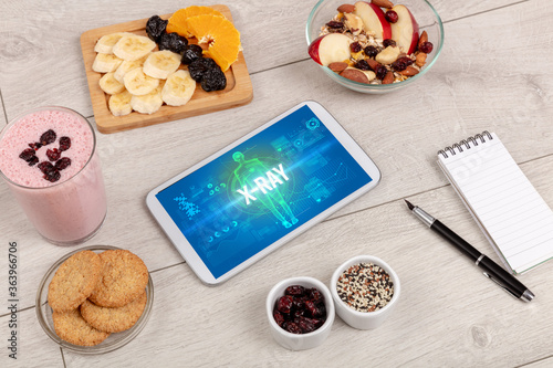 X-RAY concept in tablet with fruits, top view