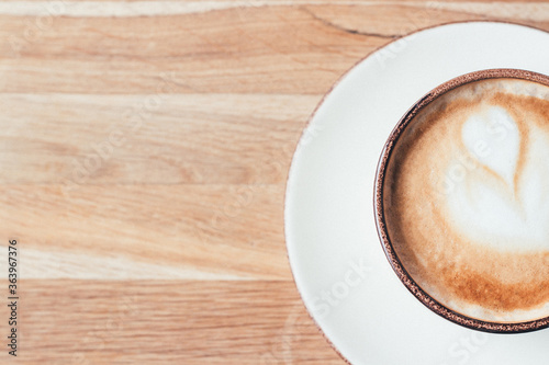 A cup of coffee on the wooden background. A place for text. Cup, coffee, latte, cappuccino, table, wooden, comfort, day.