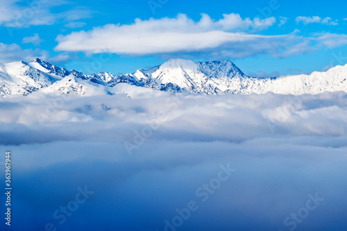View of the white cloud over the winter mountains