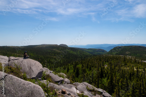 Young woman sitting in the Grands-Jardins national park, Canada 