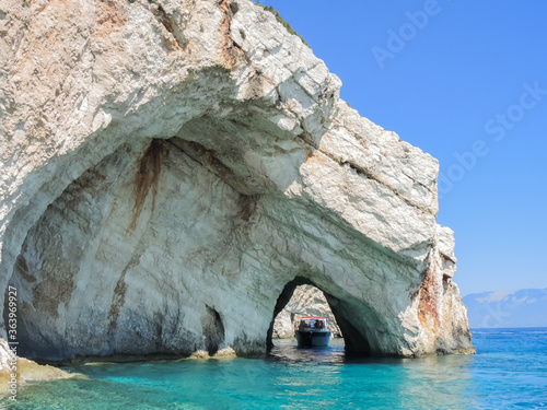 Boat with tourists passing through the Blue cave on the island of Zakynthos, Greece