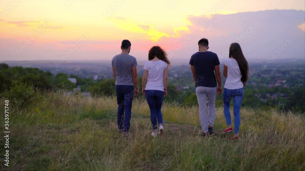 The four young people meeting sunrise on the hill The four young people meeting sunrise on the hill