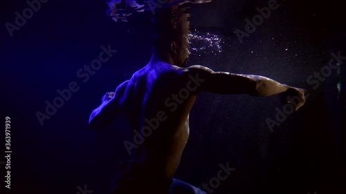 Wallpaper Mural Close-up portrait of a dark-skinned, muscular man with a naked torso. They are on a dark blue background with bubbles that swims and dances beautifully. It is reflected from the surface of the water. Torontodigital.ca