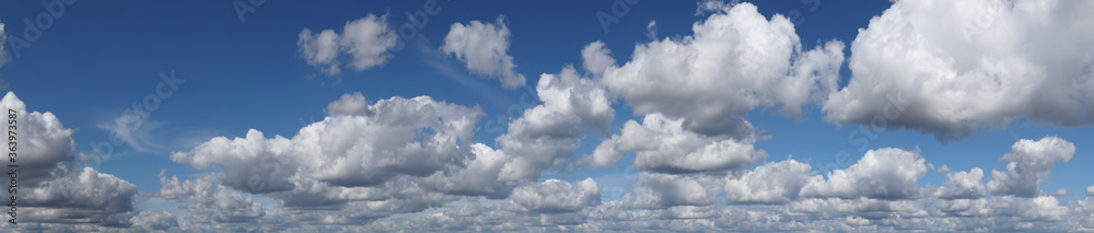 Fototapeta premium Blue summer sky with white cumulus clouds. High resolution panorama of sky with beautiful clouds. Chill out and peace, happiness and hope.