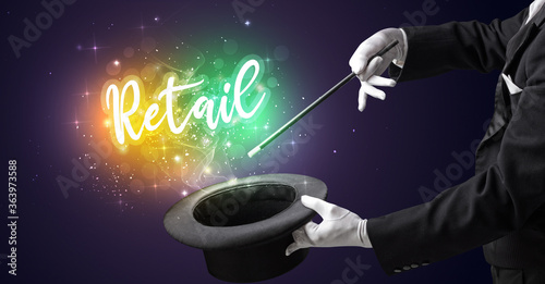 Magician hand conjure with wand and Retail inscription, shopping concept