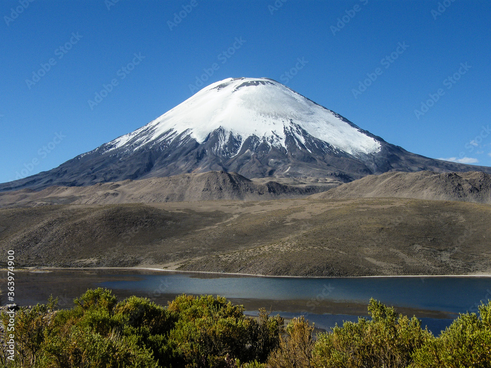 Fototapeta premium Shot of the perfectly shaped Parinacota Volcano located in the Lauca National Park in the very north of Chile, also known as Altiplano or highlands.