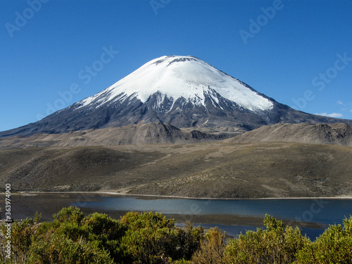 Shot of the perfectly shaped Parinacota Volcano located in the Lauca National Park in the very north of Chile, also known as Altiplano or highlands.