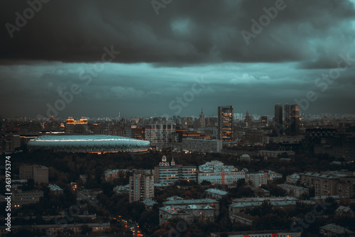 Photography Dark evening stormy cityscape: aerial view from a drone of a night urban citysca