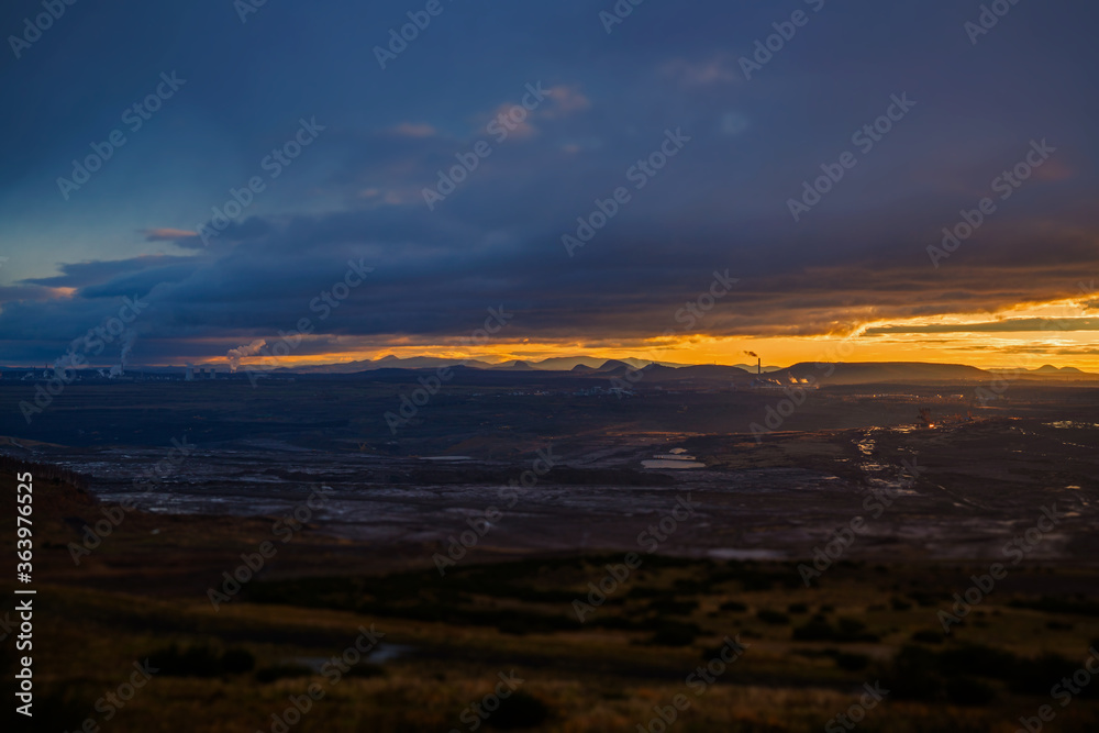Fototapeta premium sunset in czech middle mountains, lignite power plant in the background.april 2020.fullframe