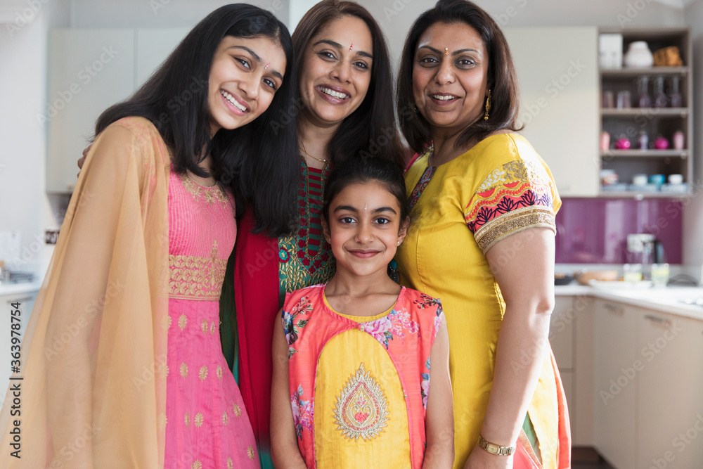Portrait happy Indian mothers and daughters in saris Portrait happy Indian mothers and daughters in saris