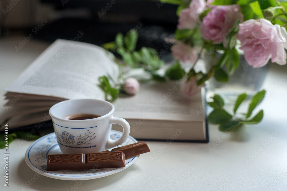 cup of coffee and book on wooden table cup of coffee and book on wooden table