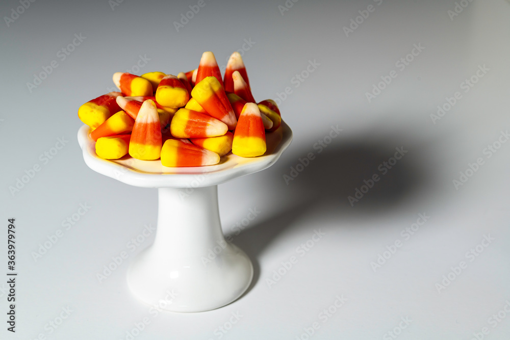 Φωτογραφία Halloween candy corn isolated on white pedestal