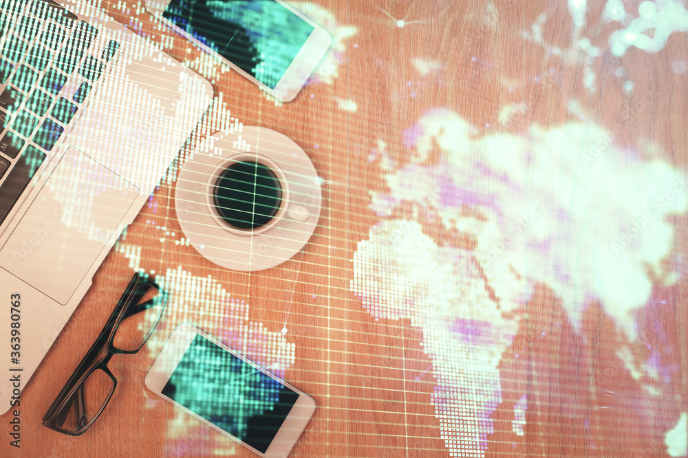 Double exposure of business theme hologram over desktop with phone. Top view. Mobile international trade connection concept.