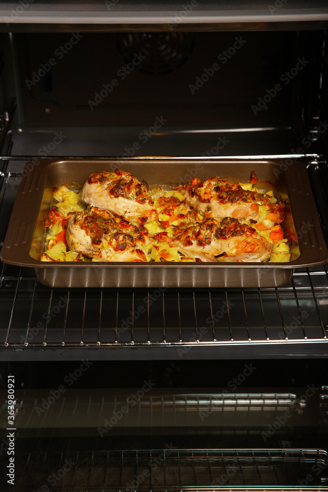 Stuffed chicken breast fillet, baked with vegetables in the oven. Cooking home-made dishes for a holiday. Recipe book. Stuffed chicken breast fillet, baked with vegetables in the oven. Cooking home-made dishes for a holiday. Recipe book.