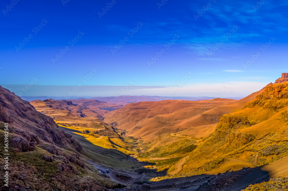 Naklejka premium Greenery in Sani pass under blue sky near kingdom of Lesotho Sou