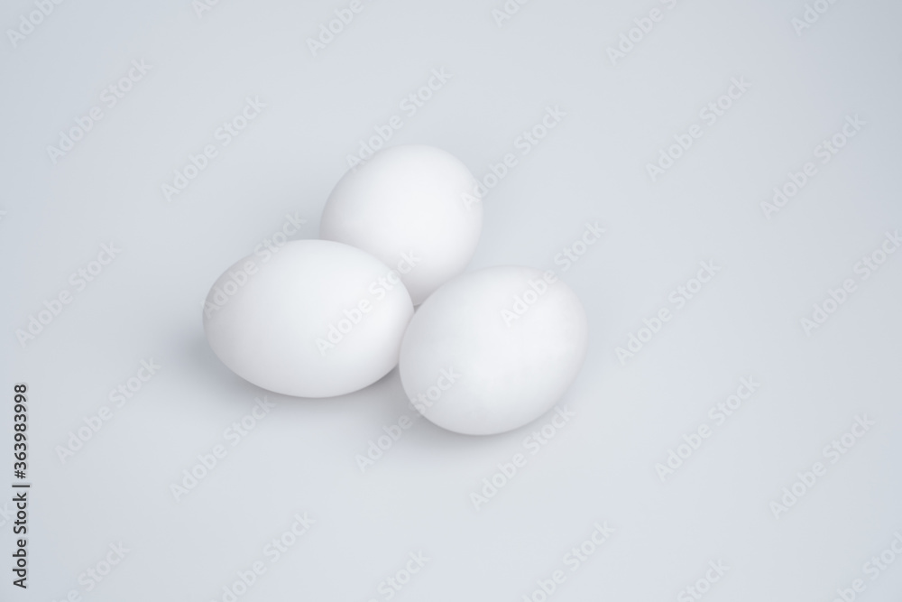 Three white eggs on a white background Three white eggs on a white background
