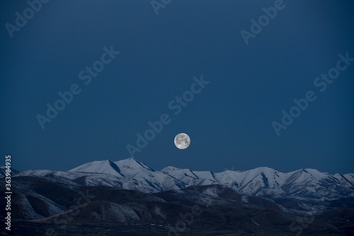 full moon over the mountains