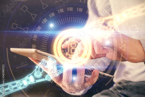 Double exposure of man's hands holding and using a phone and crypto currency blockchain theme drawing.