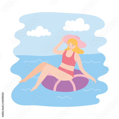 girl sunbath on ring in the swimming pool, summer vacations travel concept