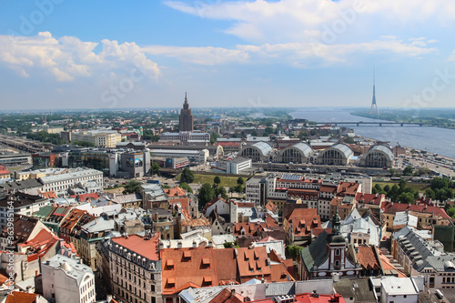 Panoramic view of Riga. Market, TV tower, red roofs of old town, Daugava river.