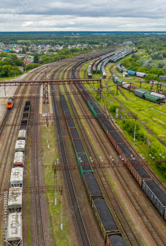 aerial photo of railway tracks where trains loaded with coal stand
