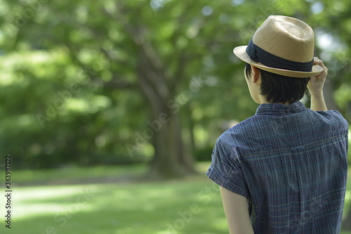 Asian young women.  like spending time in the middle of nature.   wear a hat at a rakish angle.  blurred background with copy space. © NaoakiMiyamoto
